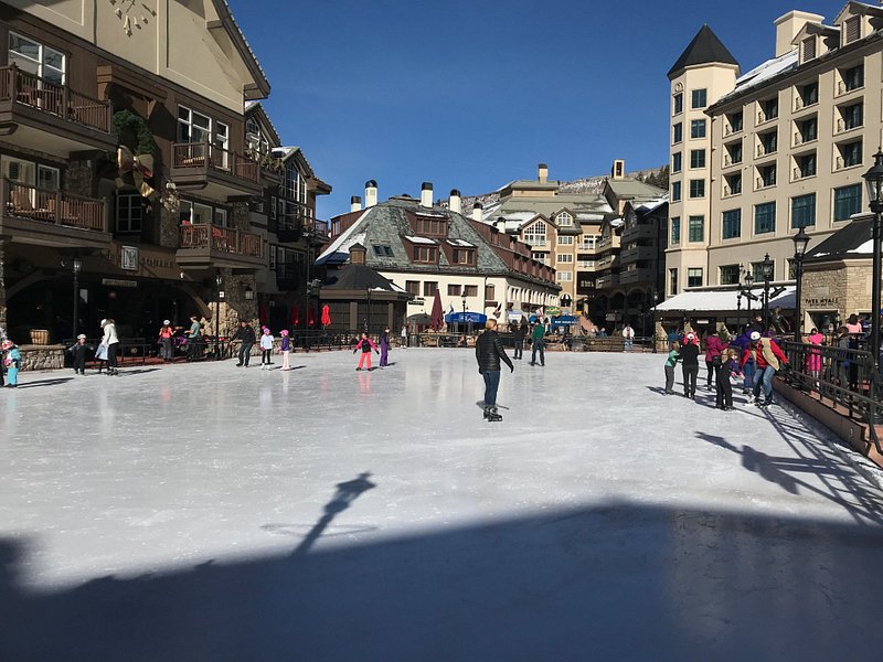 A few skaters enjoy the ice skating rink between the European-style buildings of Beaver Creek