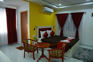 Seethala Bed & Breakfast in Pondicherry, image may contain: Chair, Bed, Home Decor, Rug
