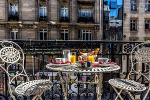 Hotel Regence Paris in Paris, image may contain: Balcony, Dining Table, Table, Dining Room