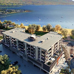 A birds-eye view of The Shore Kelowna from the back, overlooking Okanagan Lake and Gyro Beach.