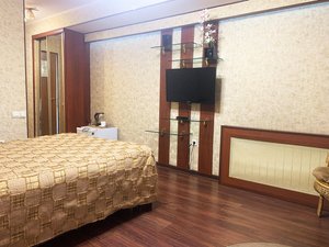 Mercury Hotel in Nakhodka, image may contain: Bed, Furniture, Interior Design, Screen