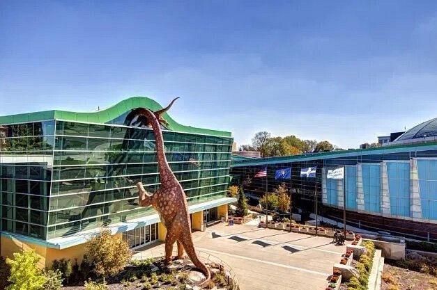 must visit places with family Dinosaur sculpture attached to building