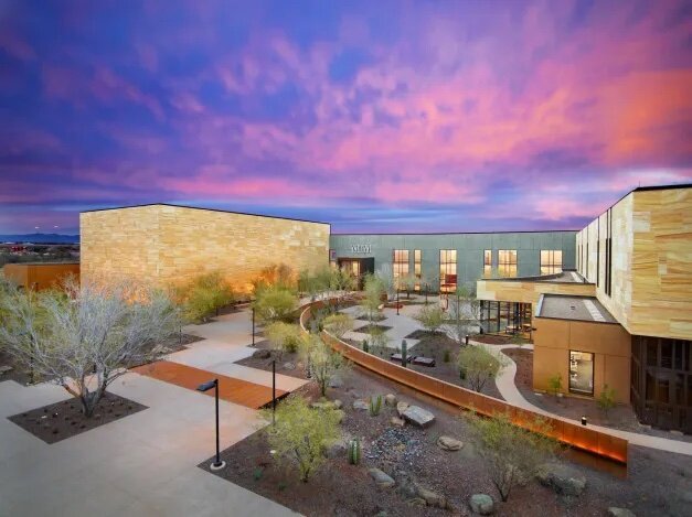 Exterior of museum with pink and blue sky above it