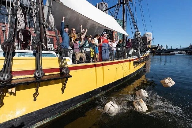 must visit places with family People throwing fake bags of tea off ship