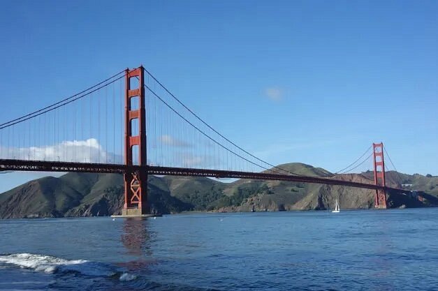 Golden Gate Bridge with green hills in background