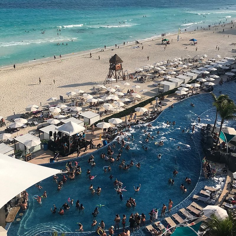 Aerial view of a Cancun resort and pool during spring break