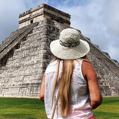 A woman standing in front of Chichen Itza near Cancun