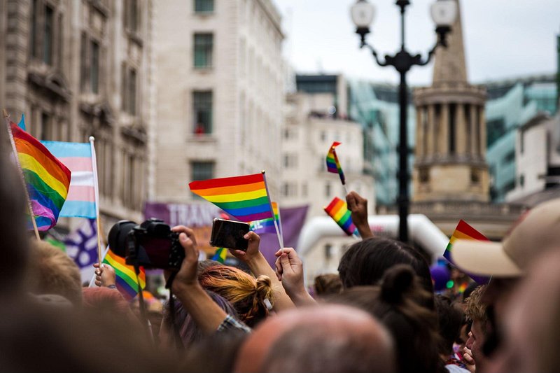 People waving Rainbow flag at Gay Pride Parade in London