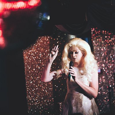 A drag queen singing at Pride's Got Talent at London pride