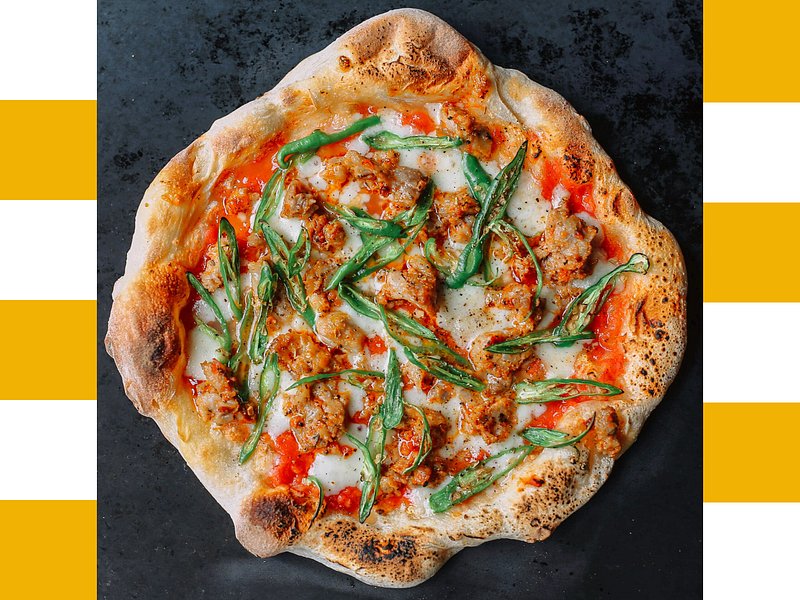 Pizza with green toppings.