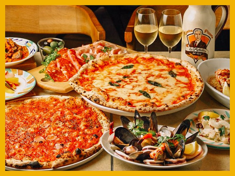 Pizza spread on table with black backdrop