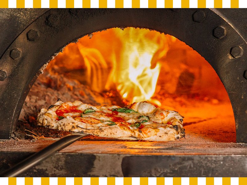 Pizza going into a pizza oven