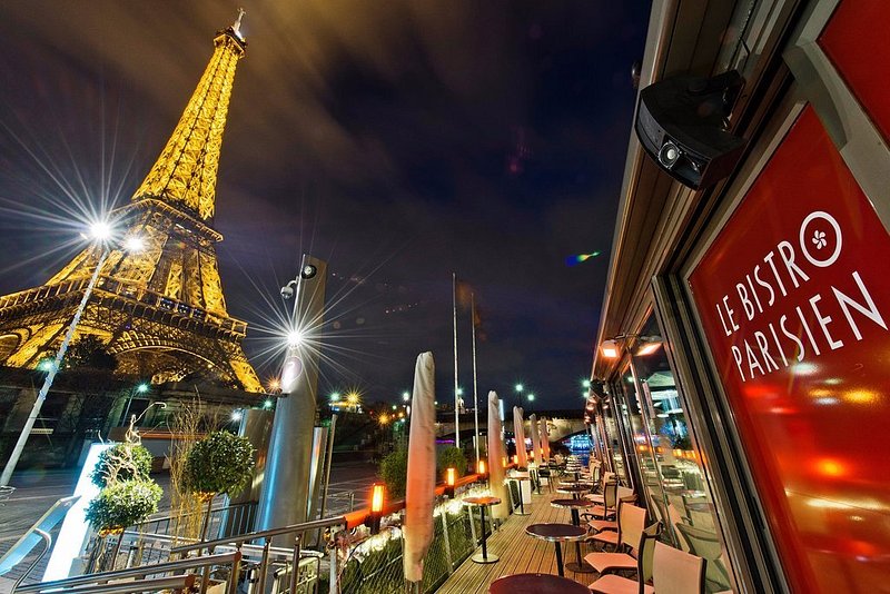 View of illuminated Eiffel Tower at night from Le Bistro Parisien in Paris