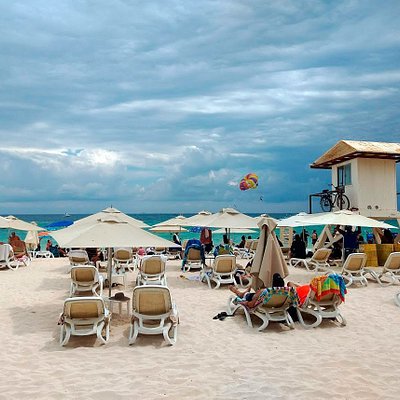 People lazing on beach chars at Mamita's Beach Club in Cancun