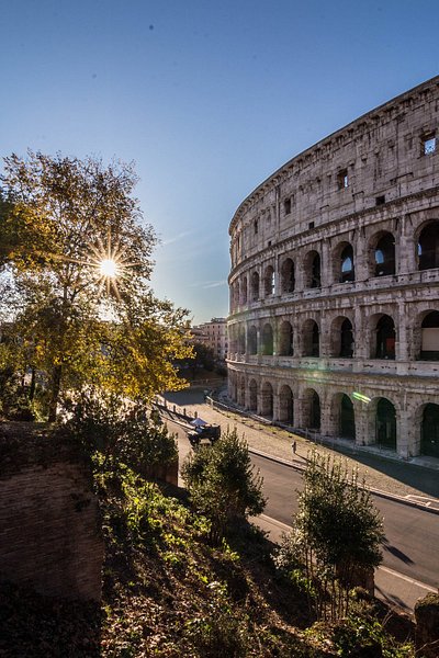 View of the Colosseum in Rome with the sunlight peeking through
