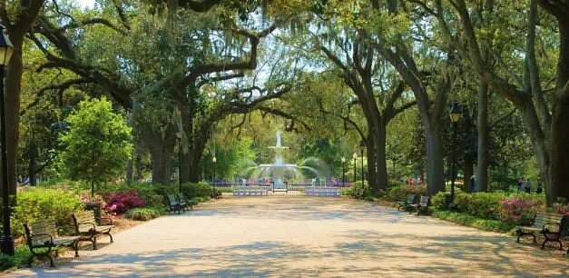 Forsyth Park with benches, water fountain, and ample green trees