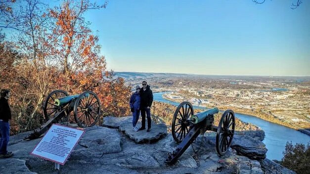 Two people between cannons overlooking river on Lookout Mountain