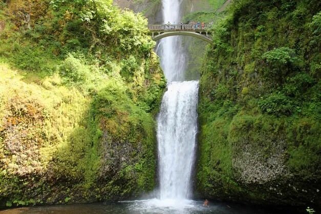 Large waterfall with bridge over it