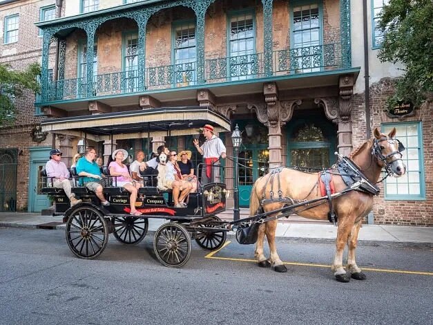 Several people in horse-drawn carriage in Charleston