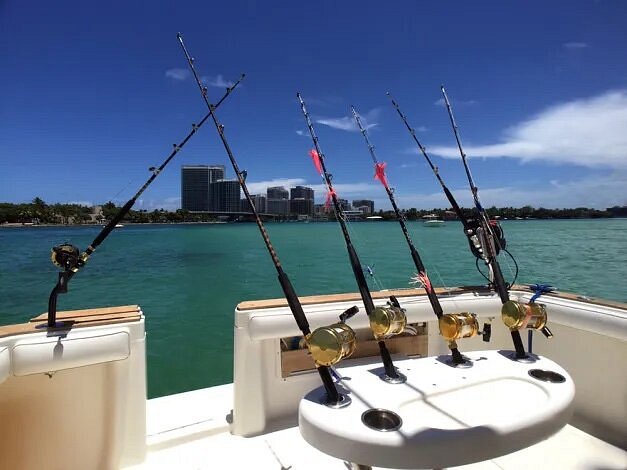 Six fishing poles secured in boat on the ocean