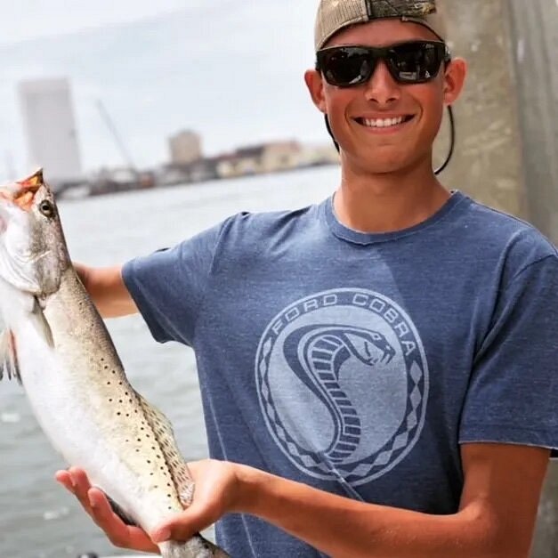 Young person holding up fish