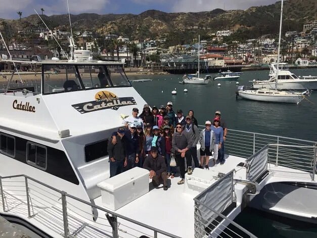 Group of people on boat with Catalina Island in background