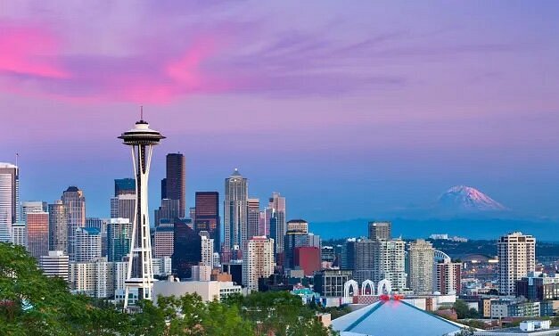 Space Needle and surrounding buildings with purple and blue sky