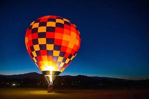 Hot air balloon on ground while it's dark out