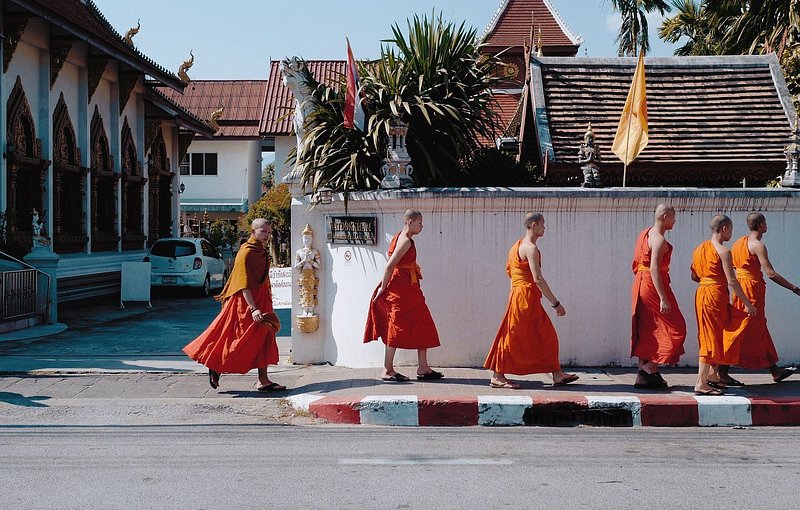 Monks in Chiang Mai, Thailand walking on sidewalk