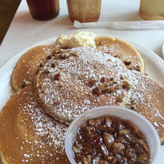 Plate of pancakes with cup of pecans