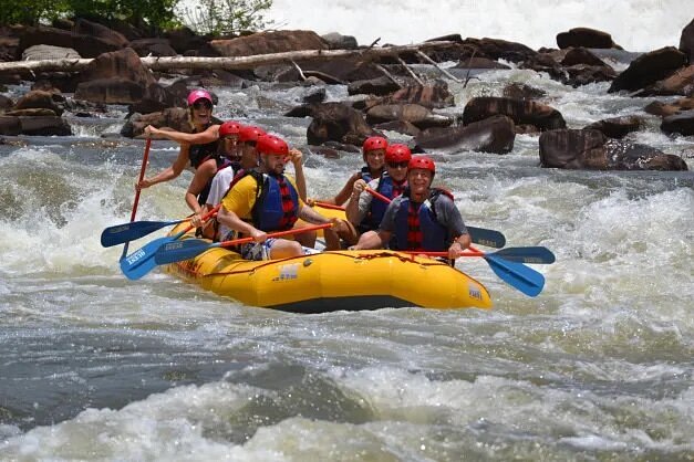 People in yellow raft rowing amid rapids