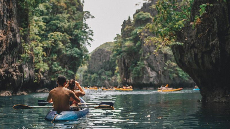 A couple kayaking in Small Lagoon, El Nido, Philippines