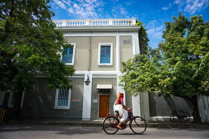 A woman cycling in the French colony Pondicherry