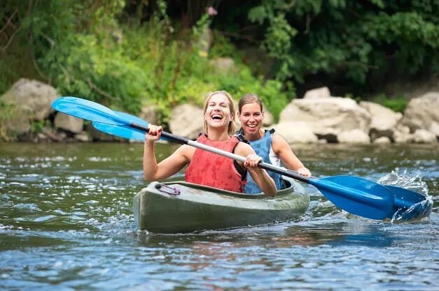 Two people kayaking on river