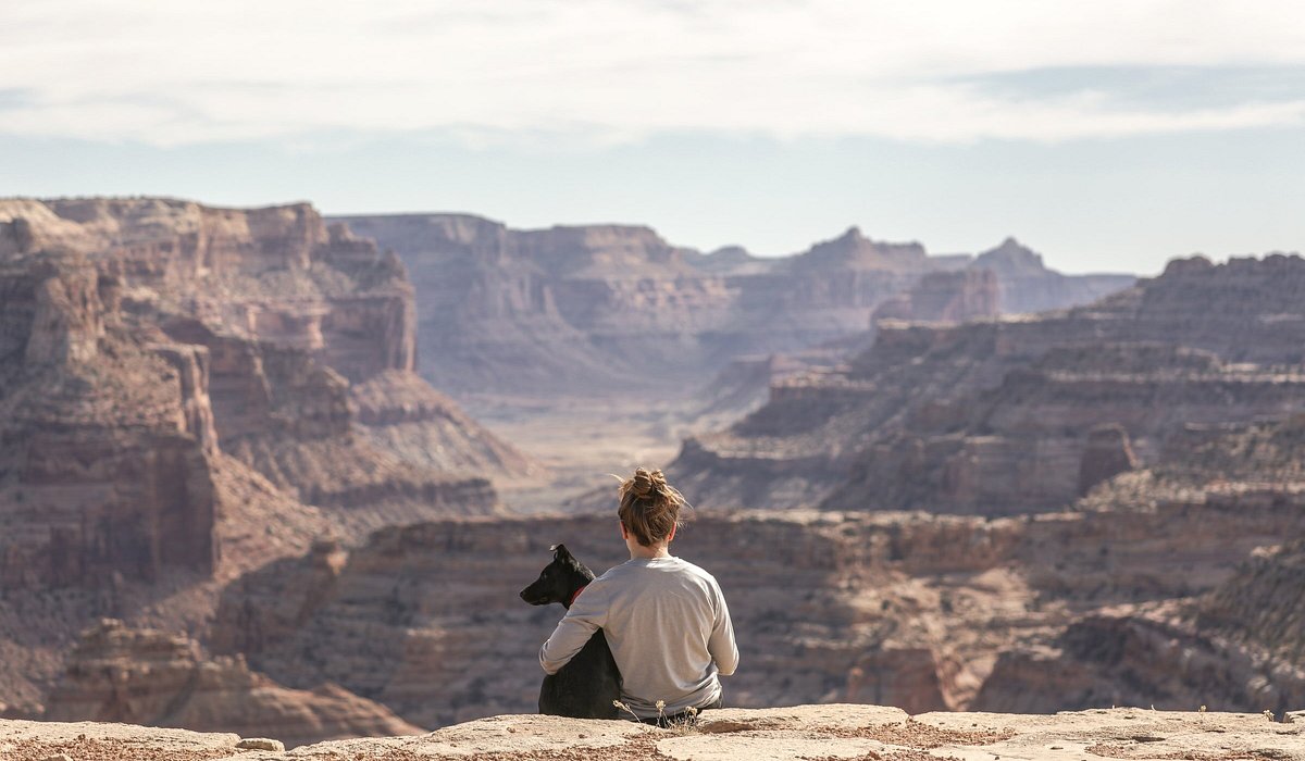 A woman hugging her dog at Little Grand Canyon in Utah