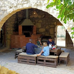 Family having breakfast in the cool courtyard in summer.