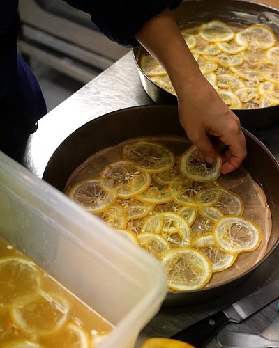 A chef preparing a lemon tart at Cafe du Coin bistro in Paris