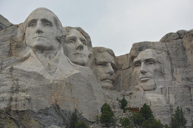 The four faces of George Washington, Thomas Jefferson, Theodore Roosevelt and Abraham Lincoln carved out of mountain stone in Mount Rushmore National Park