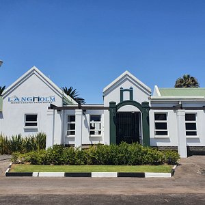 The Langholm Hotel in Walvis Bay, image may contain: Hotel, Building, Bench, Villa
