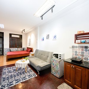 The room has a spacious sofa area and kitchen space.