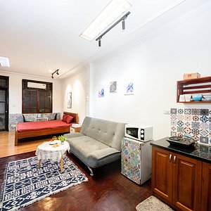 The room has a spacious sofa area and kitchen space.