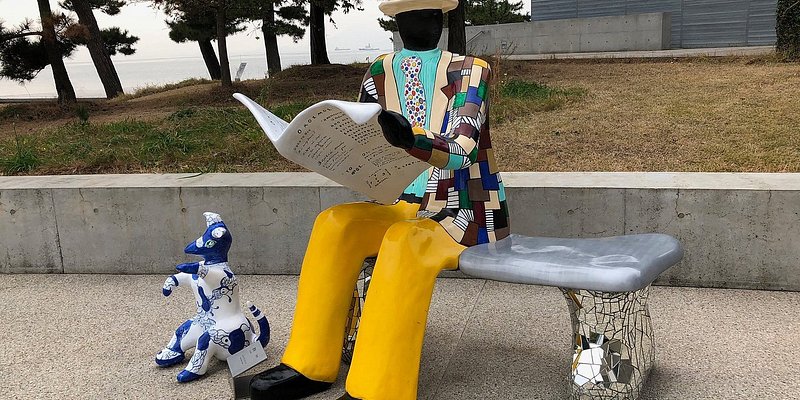 Sculpture of a man sitting on a bench at the Benesse House Museum in Japan