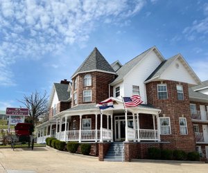 Carriage House Inn in Branson, image may contain: Flag, Housing, Neighborhood, House