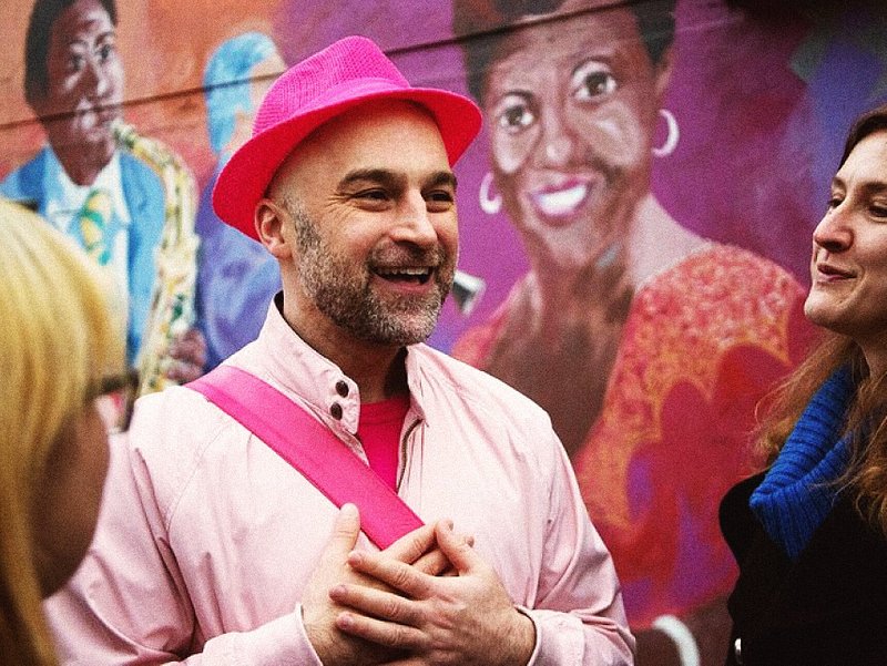 A photo of the tour guide for The Really Gay History Tour in Vancouver, Canada wearing all pink