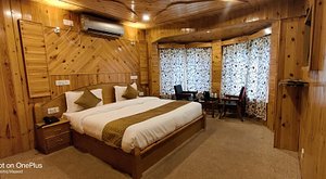 Hotel Bombay Palace in Pahalgam, image may contain: Interior Design, Indoors, Wood, Bed