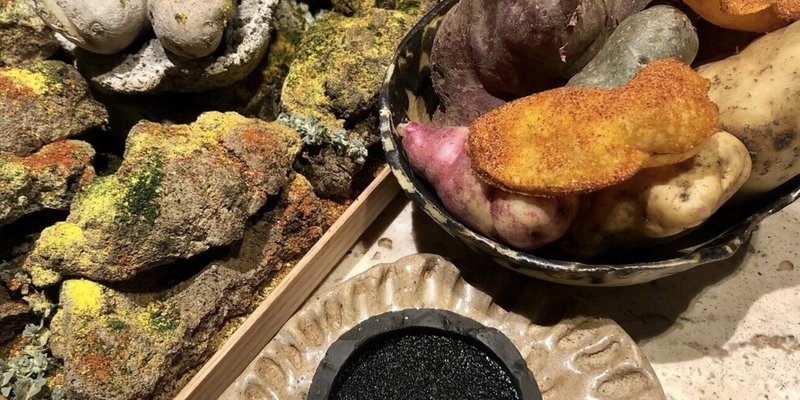 Table of food made to imitate rocks and earth