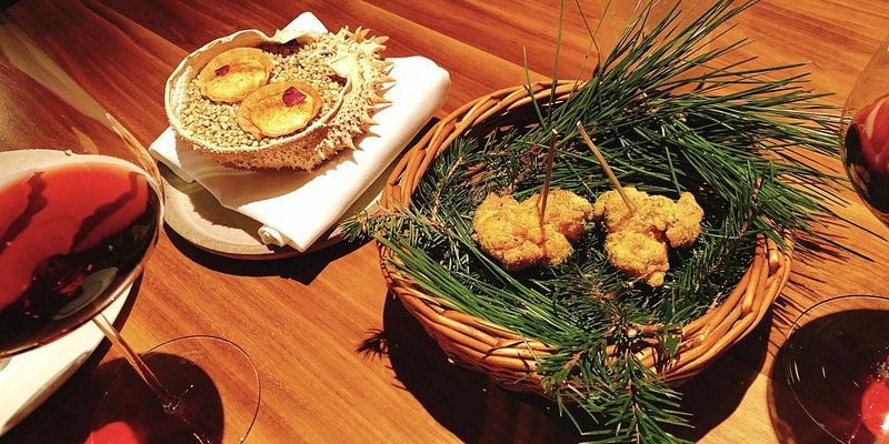 An assortment of seafood and glasses of red wine