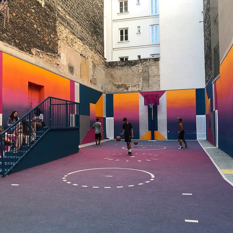 People playing basketball at Playground Duperre in Paris