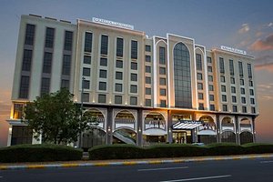 Ayla Grand Hotel in Al Ain, image may contain: Office Building, Hotel, Condo, City