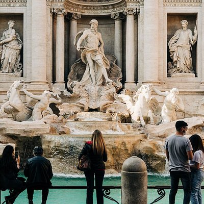 People admiring the Trevi Fountain in Rome